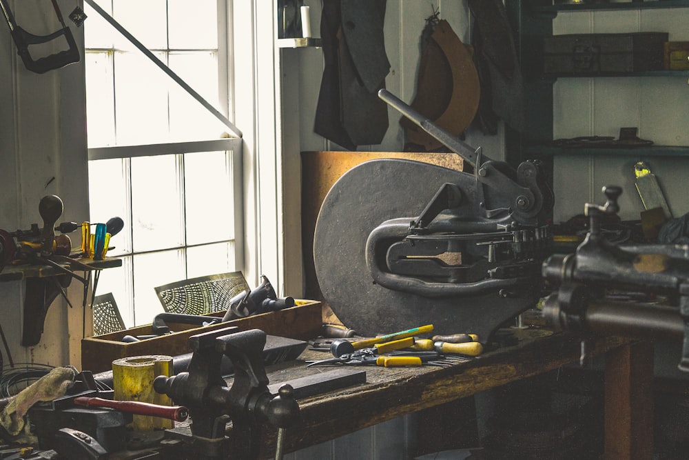 black bench vise on brown wooden work bench