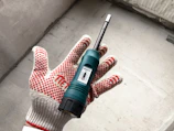 Inspector using moisture meter on a Roswell home's wooden floor to detect dampness.
