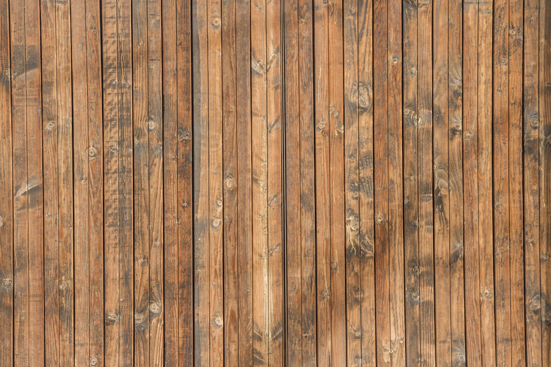Close-up of natural cedar-tone vertical fence boards