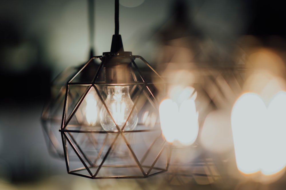 selective focus photography of brass-colored pendant lamp