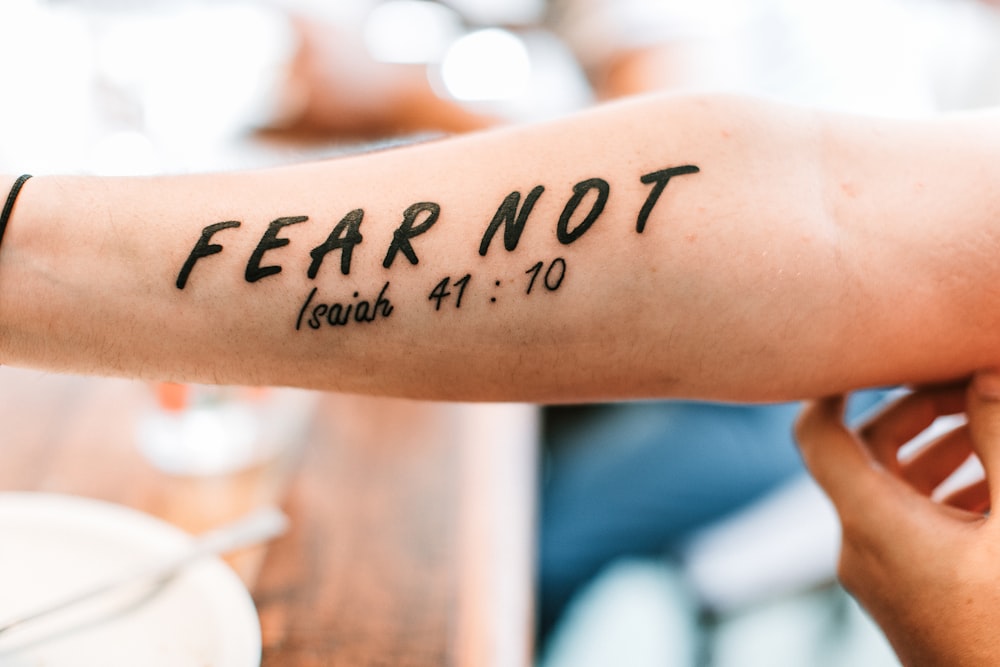 person with fear not tattoo on arm