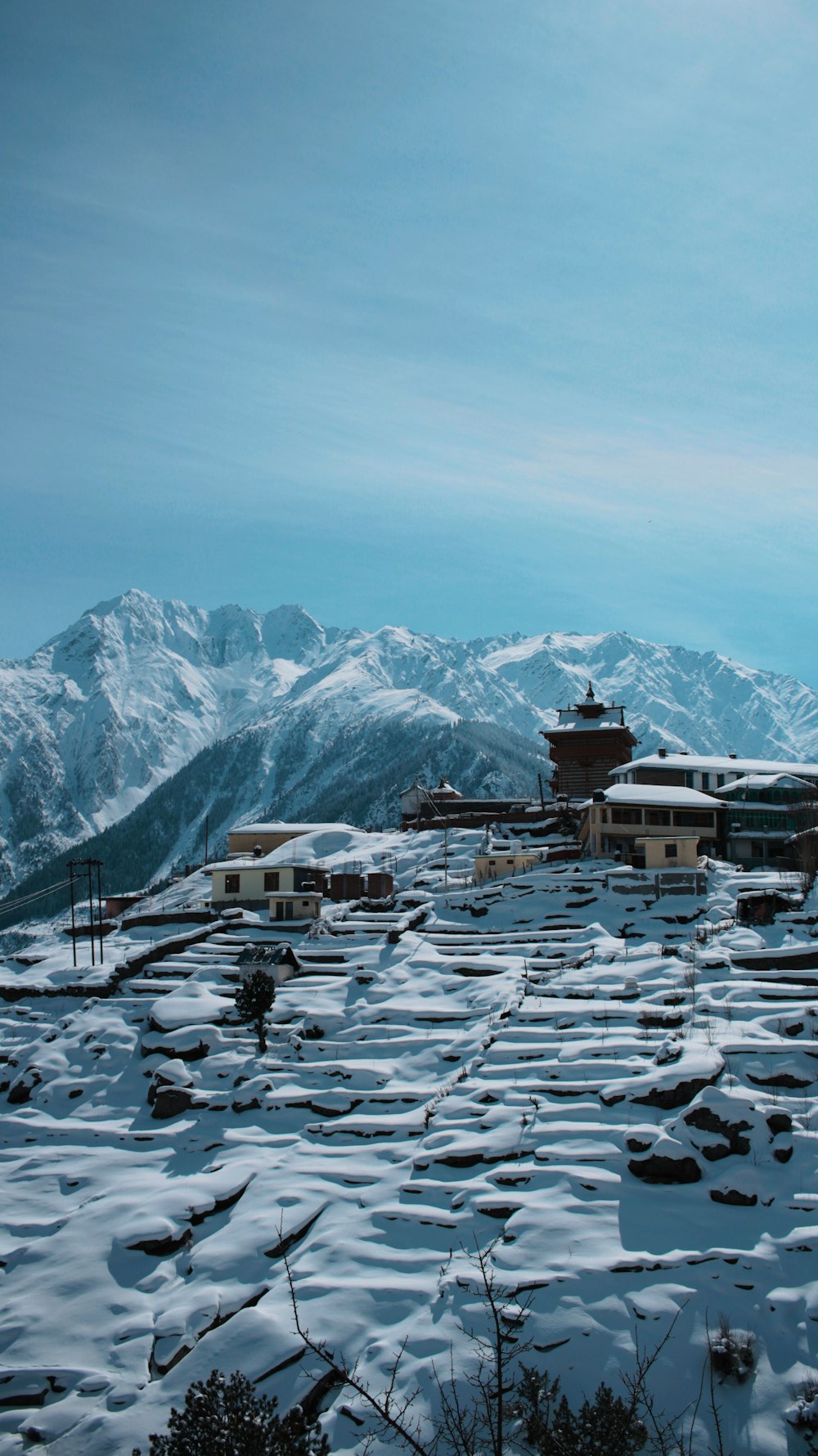 aerial photography of snow-covered village on top of the hill during daytime