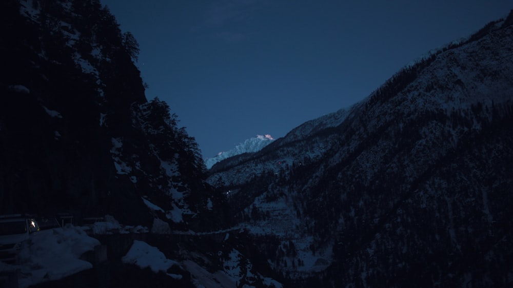 mountain range under blue sky at night