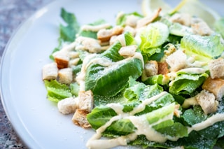 closed photography of vegetable salad with croutons in plate