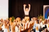 people raising hands with bokeh lights