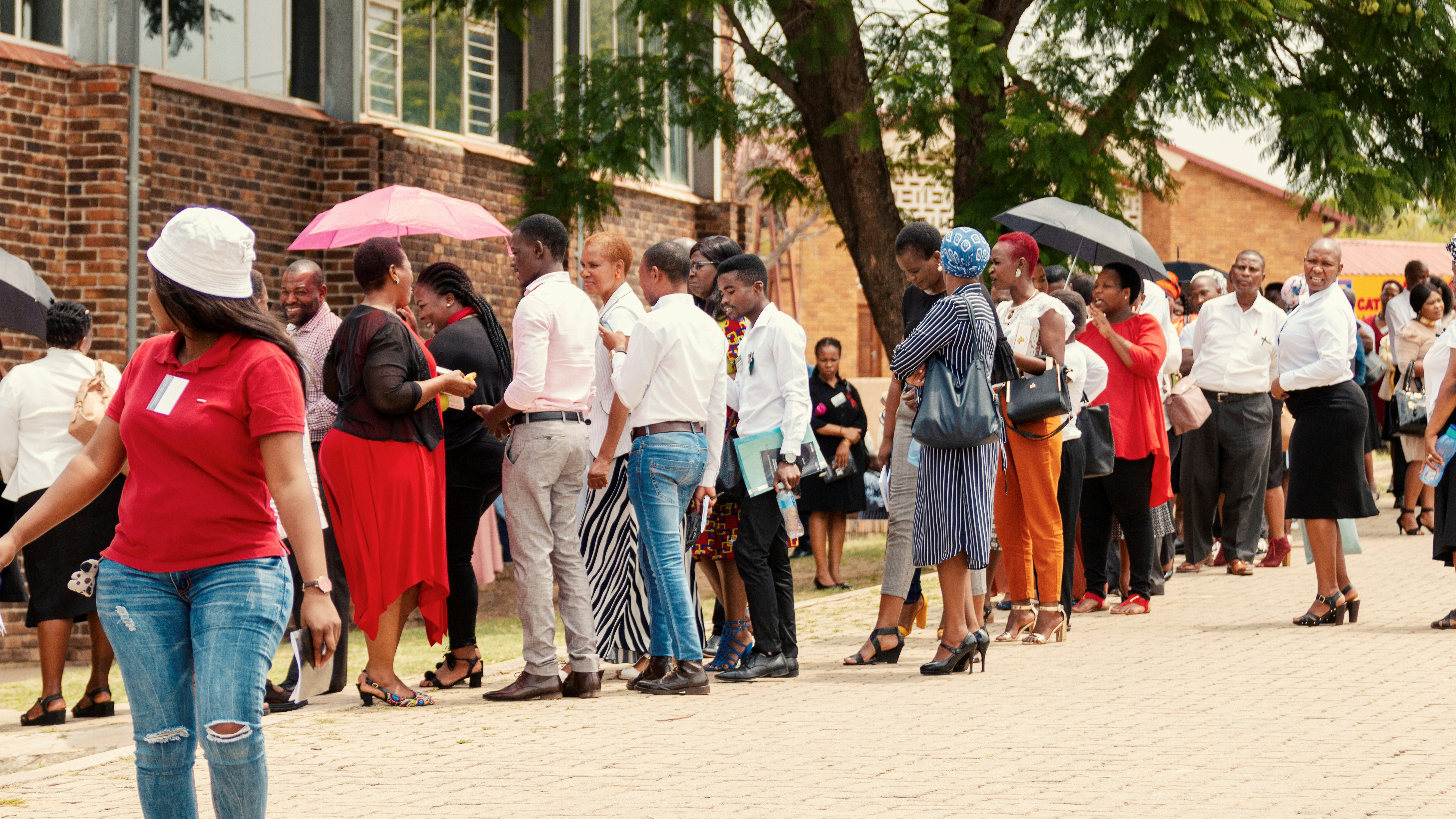 A crowd of people raising their hands to vote.