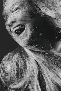 Dynamic black and white portrait of a fitness influencer in motion, embodying energy and authenticity.