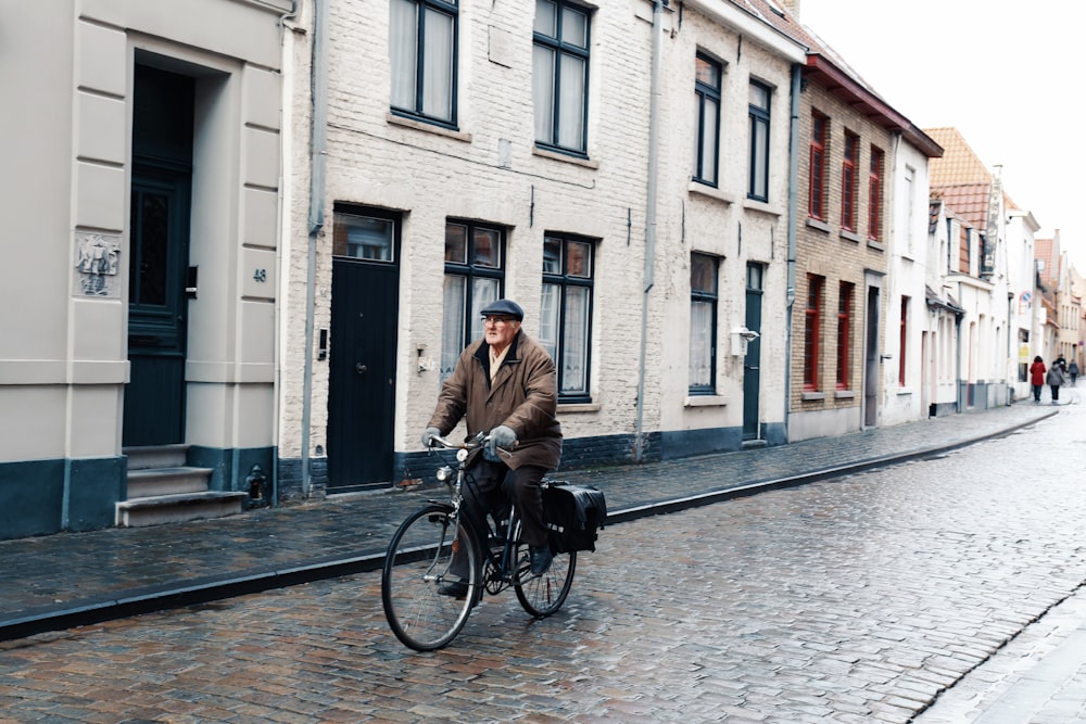 man biking on wet road during daytime