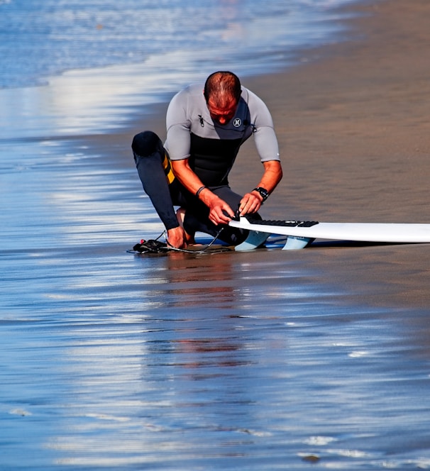 man holding surf board