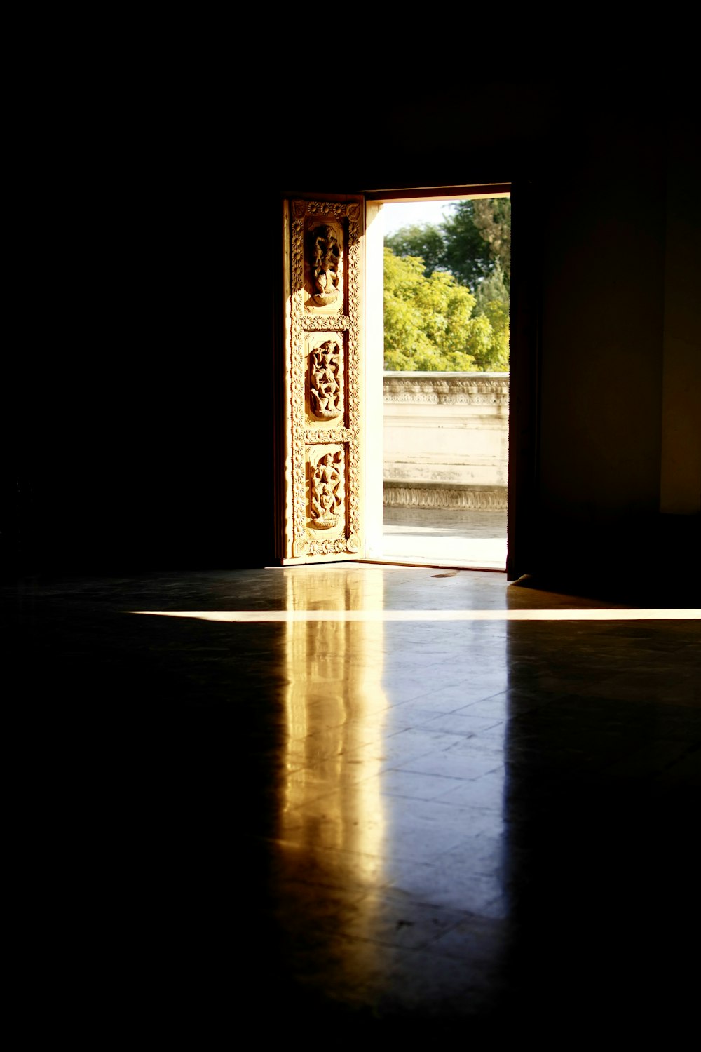 brown wooden door open during daytime