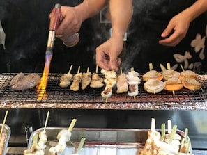 Chef expertly grilling traditional Japanese skewers with a modern twist at Tori Fuego