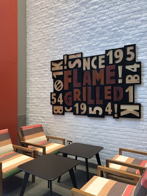 Close-up of stylish event seating arrangements with bold typography artwork on walls.
