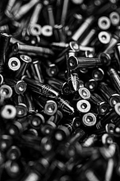 selective focus photography and grayscale photograhy of ammunation