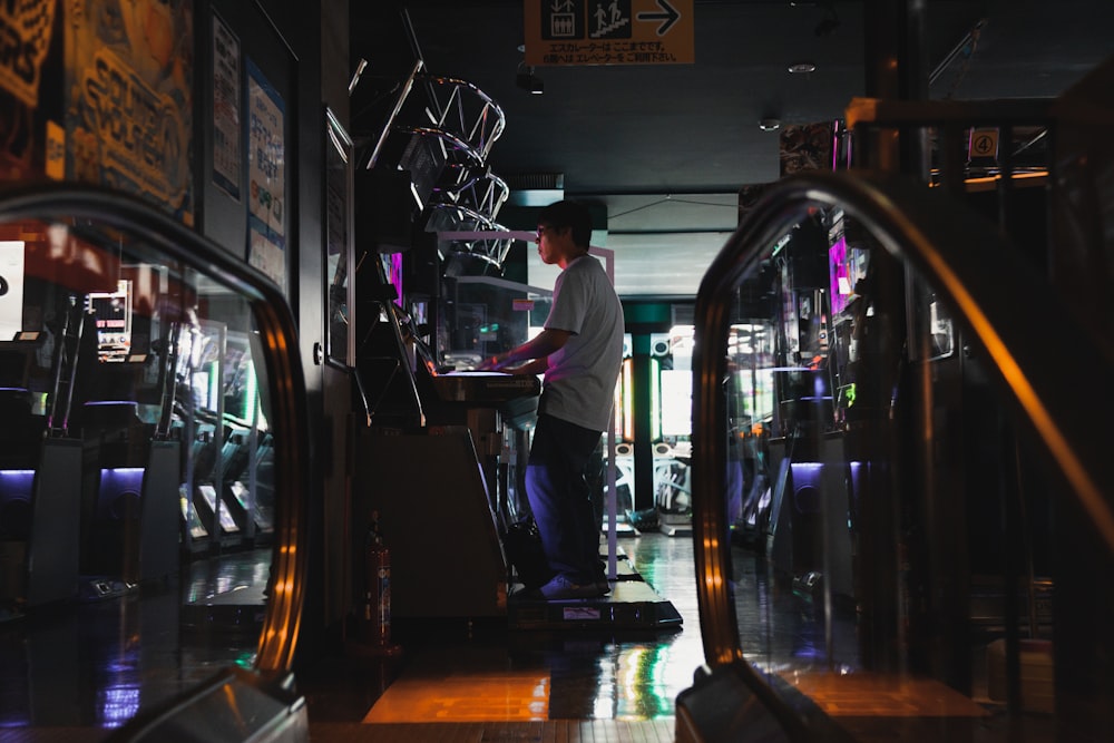 man playing on game arcade