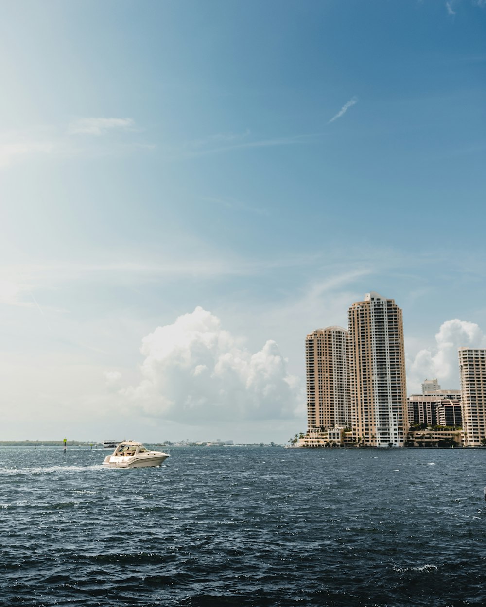 boat on body of water near buildings