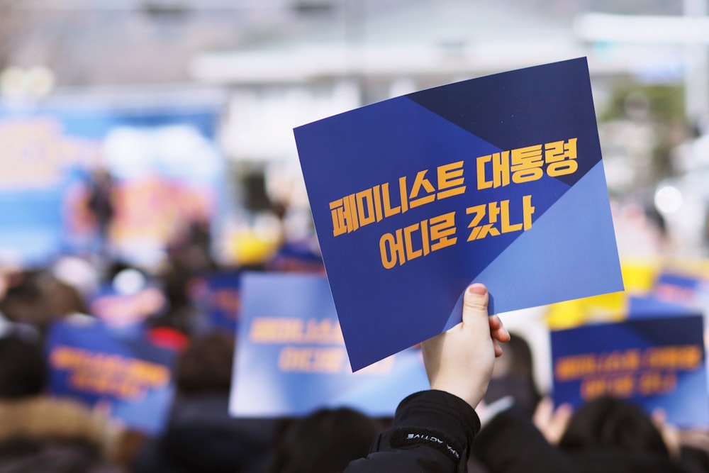 person holding blue paper