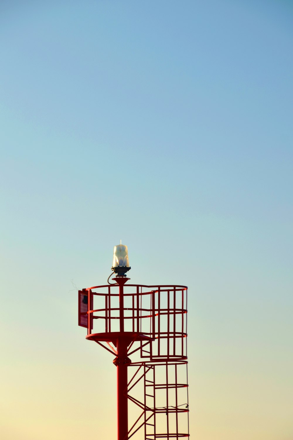 red metal tower at daytime