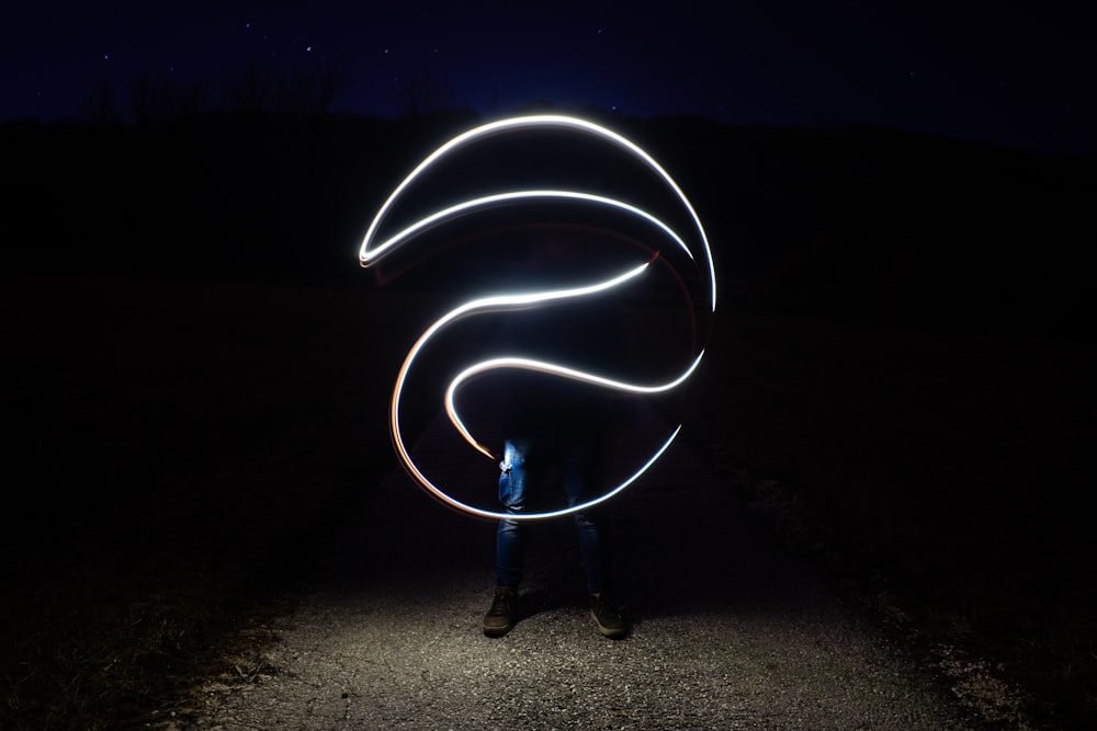 person performing light tricks during daytime