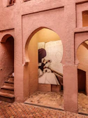 Cozy nook with terracotta walls, soft gold accents, and a maker sketching designs.