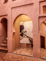 A candid interaction between a writer and client, surrounded by warm terracotta walls.