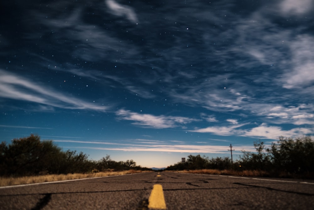 gray asphalt road under clear blue sky