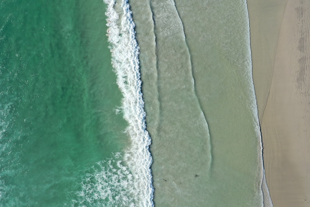 waves bashing on shore during daytime