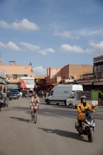 A vibrant city street scene with people riding Hypertech electric scooters and bicimotos under a clear blue sky.