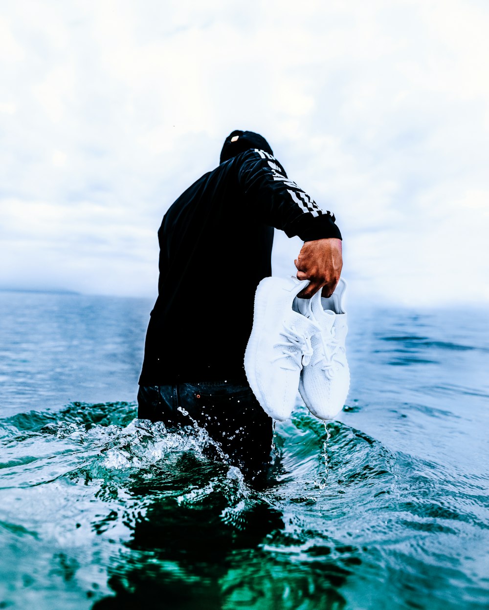 man wearing black long-sleeved shirt on water