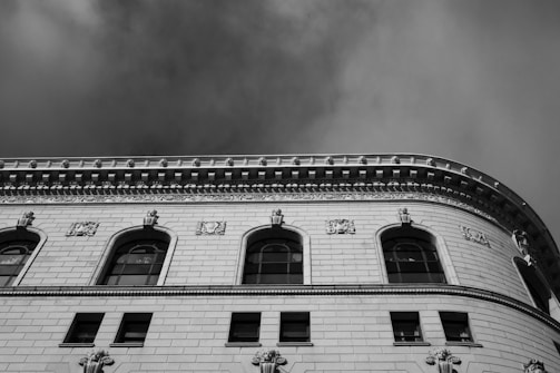 Black-and-white photo of a restored historical building facade with bold architectural lines.