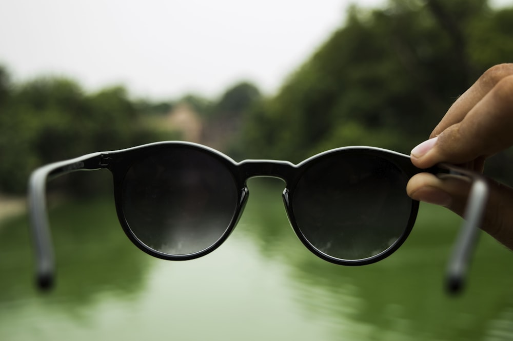 person holding sunglasses