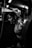 greyscale photo of woman in bralette inside room
