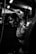 greyscale photo of woman in bralette inside room