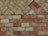 A geometric pattern of bricks arranged in two distinct sections, with the top displaying a diagonal herringbone layout and the bottom featuring a horizontal alignment. The bricks show signs of wear, suggesting an aged appearance.