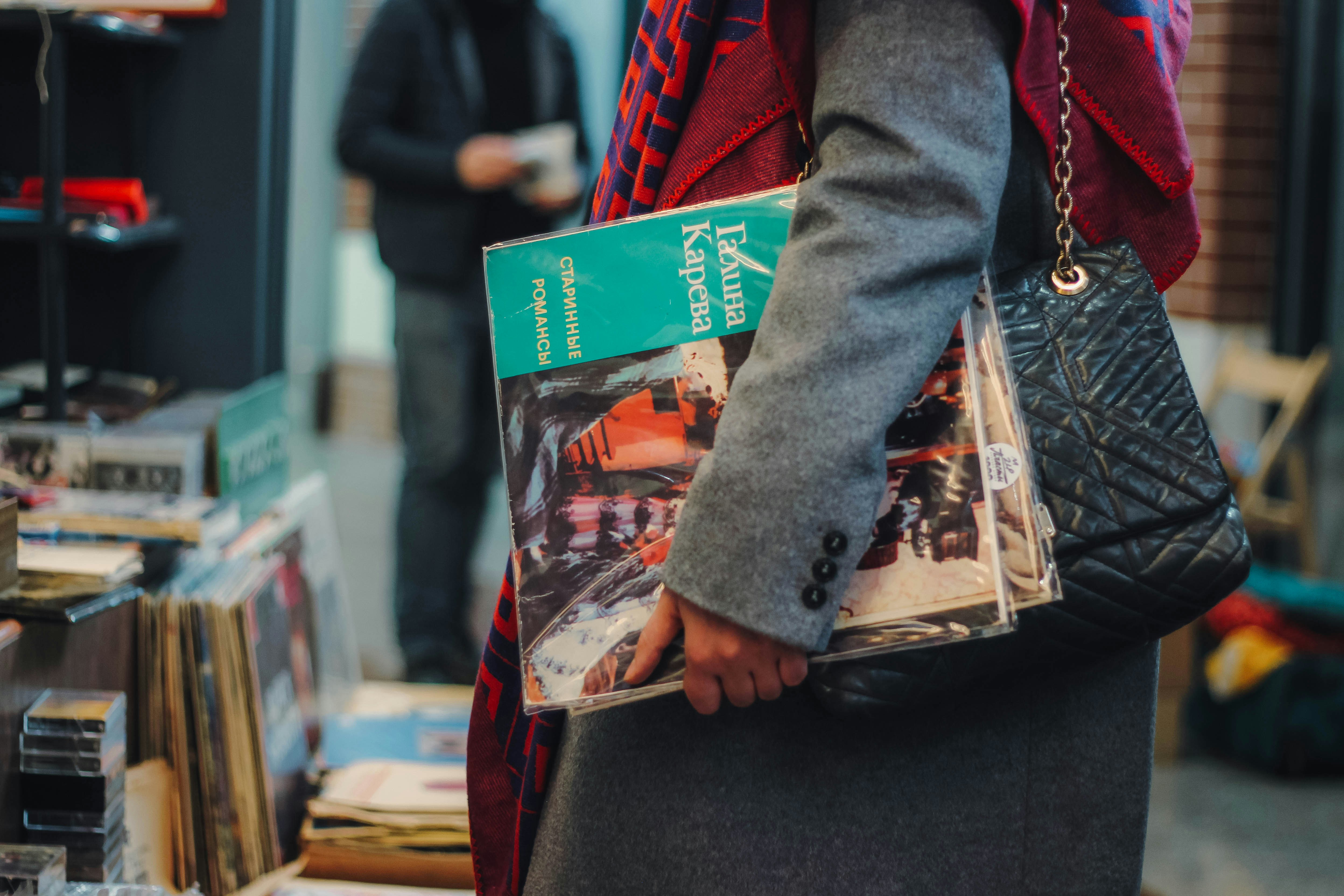 woman carrying assorted-title magazines