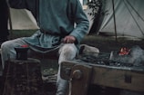 person in gray shirt sitting on wooden bench