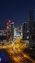 high-angle photography of cars on road between high-rise buildings