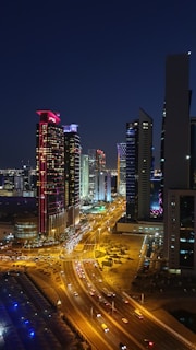 high-angle photography of cars on road between high-rise buildings