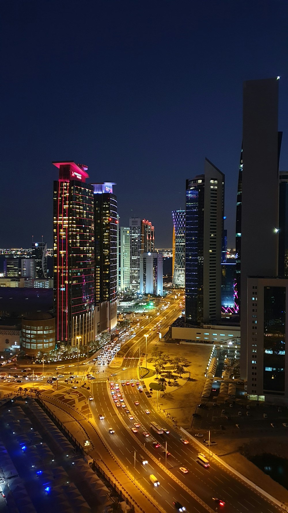 high-angle photography of cars on road between high-rise buildings