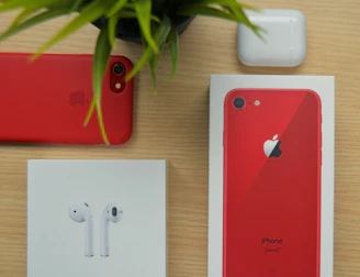 A sleek iPhone 15 Pro Max case resting on a wooden table beside a small potted plant.