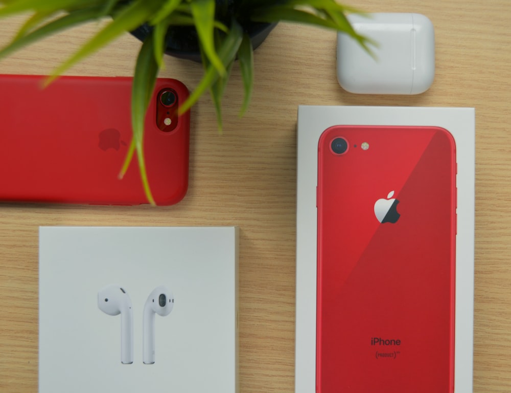 product red iphone 7 with box on table