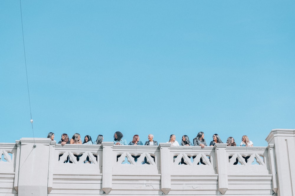 women standing in front of handrail