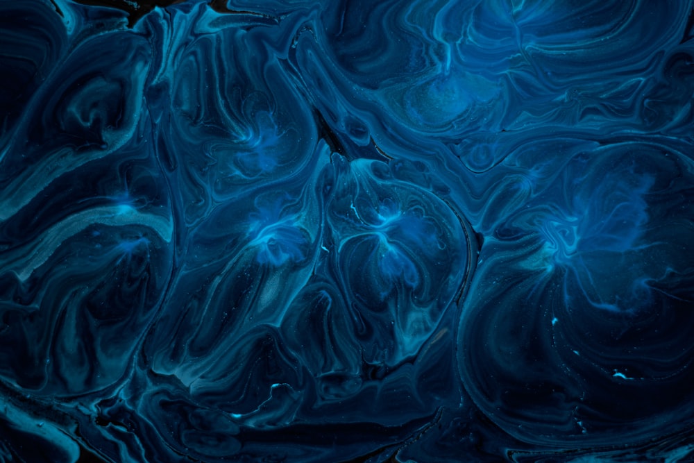 a blue and black background with swirls and bubbles