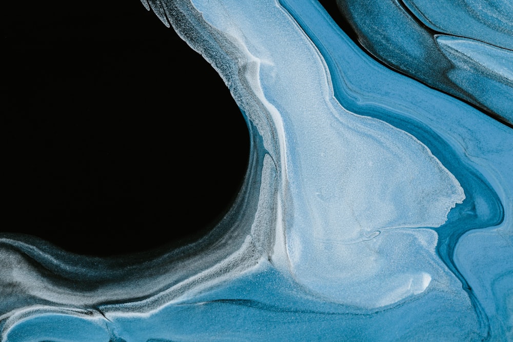 a black background with blue and white swirls