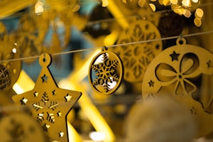 Close-up of a custom engraved wooden ornament with a holiday message.