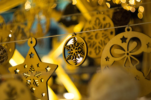 Close-up of a delicate wooden Christmas ornament with intricate hand-painted details, resting on a soft linen cloth.