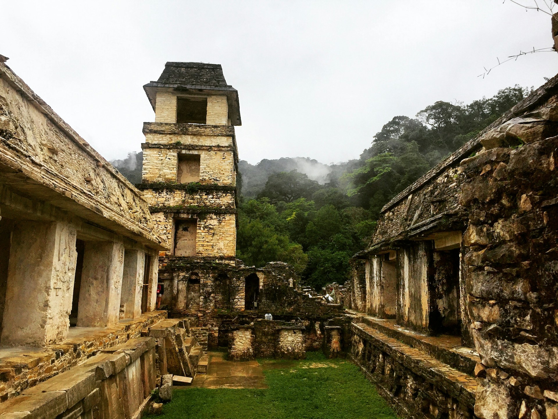 Lara Croft-style explorer standing confidently in a dense jungle with ancient ruins in the background, evoking a sense of adventure.