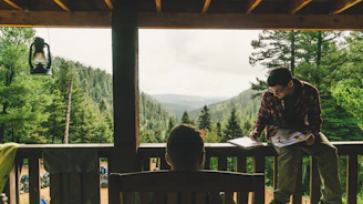 man holding book near tree during daytime