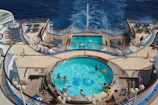 The experienced swimming coach giving tips to swimmers on the ship's deck.