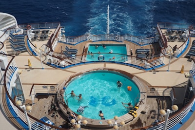 Royal Caribbean cruise ship with passengers enjoying a pool deck party.