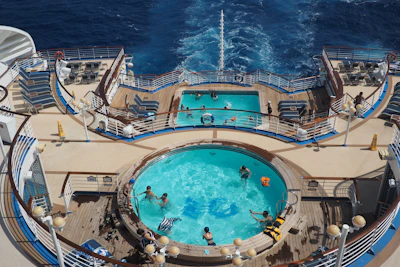 The experienced swimming coach giving tips to swimmers on the ship's deck.
